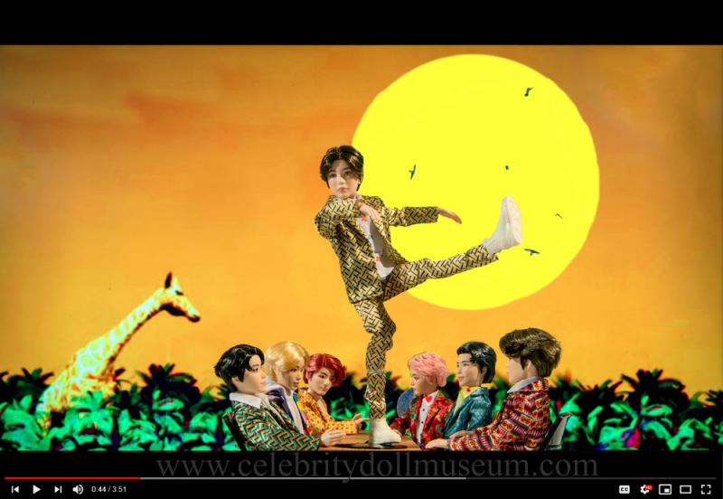 SUGA and BTS as dolls in an IDOL video still